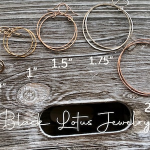 May include: A collection of hoop earrings in various sizes and metallic finishes, including gold, rose gold, and silver. Sizes range from 1/2 inch to 2 inches. The brand name "Black Lotus Jewelry" is displayed.