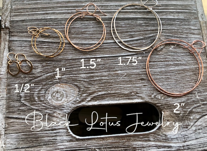 May include: A collection of hoop earrings in various sizes and metallic finishes, including gold, rose gold, and silver. Sizes range from 1/2 inch to 2 inches. The brand name "Black Lotus Jewelry" is displayed.