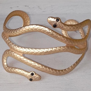 Gold metal Snake  bracelet with black stone eyes--1990s