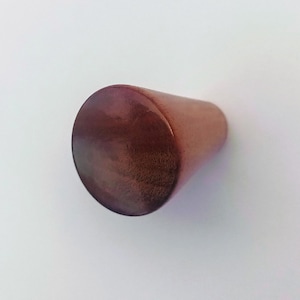 May include: A dark brown wooden knob with a rounded top and a tapered bottom.