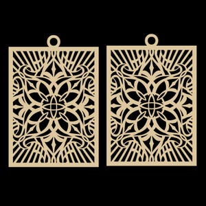 May include: Two laser-cut, beige-colored earrings with an intricate floral and geometric design. Each earring is rectangular with a small circular loop at the top for hanging. The design features a central floral motif surrounded by swirling patterns and linear elements.