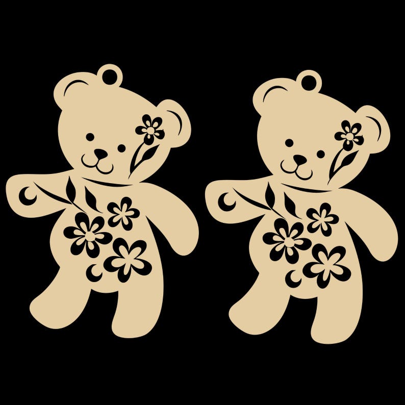 May include: Two tan teddy bear cutouts with black floral designs. Each bear has a small loop at the top for hanging. The bears have black eyes, noses, and floral accents on their bodies and heads. The background is black.