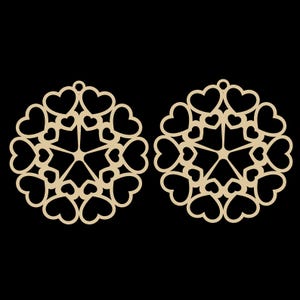 May include: Two laser-cut wooden ornaments, each featuring a circular design composed of heart shapes. The ornaments are a light tan color and have a small hole at the top for hanging. The background is solid black.