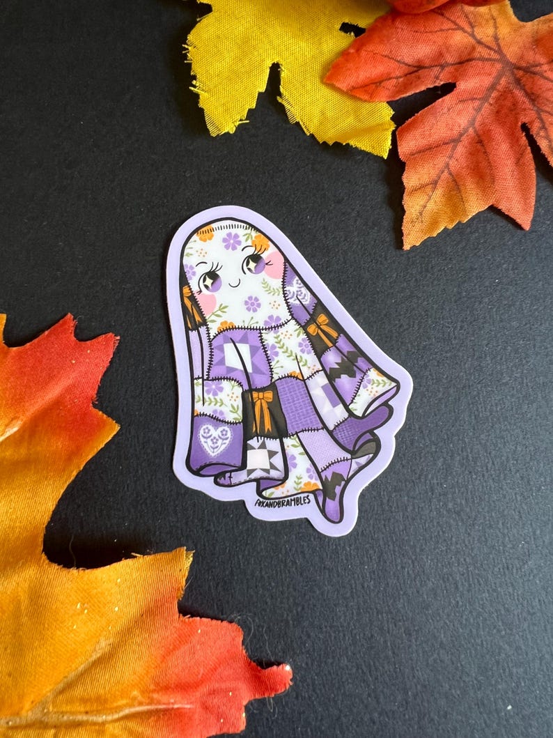 a sheet ghost with various purple, white, orange quilt patterns to resemble a quilt