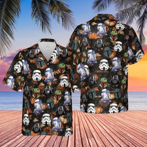 May include: Black short-sleeve button-down shirt with a Star Wars-themed pattern. The design features images of R2-D2, Darth Vader, Stormtroopers, and Boba Fett helmets, along with pumpkins and autumn leaves.