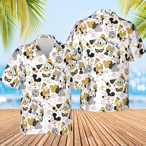 May include: White button-down shirt with a festive New Year's design. The shirt features cartoon characters, champagne bottles, disco balls, and the text "New Year" in a repeating pattern. The shirt has short sleeves and a collared neckline.