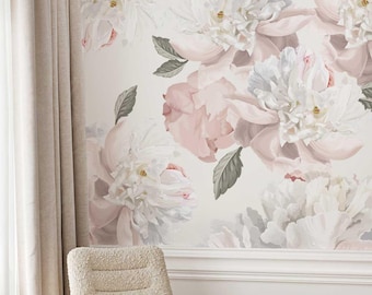 May include: A wall mural featuring large, watercolor-style peonies in shades of white and blush pink. The floral design includes green leaves and is set against a light background. A beige chair and curtains are in the foreground.