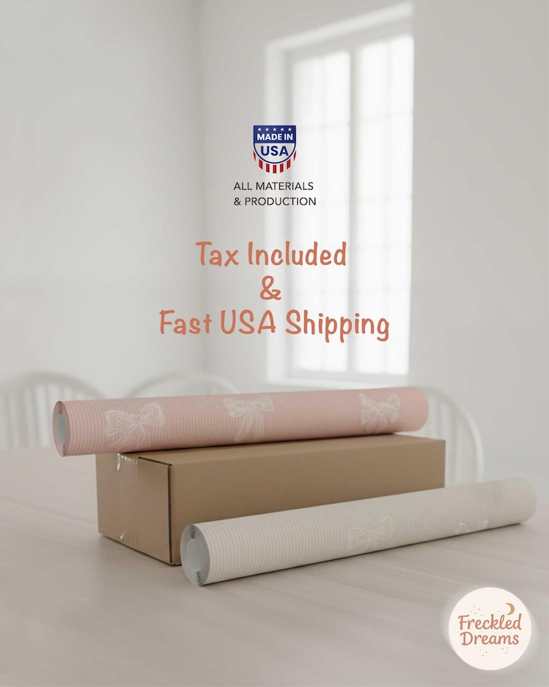 May include: Two rolls of wallpaper, one pale pink with a bow design and one white, are displayed on a table. A cardboard box is beneath the pink roll. The image includes the text "Made in USA".