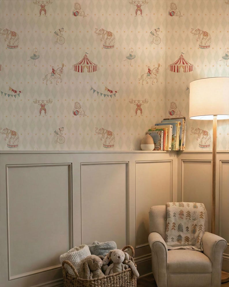 May include: A room decorated with circus-themed wallpaper showing elephants, acrobats, and tents. There's a light-coloured armchair with a blanket, a basket of soft toys, and a floor lamp. The walls are painted in a neutral colour.