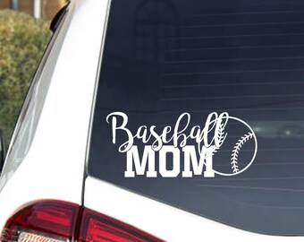 May include: White vinyl decal on a car window. The decal reads "Baseball MOM" in a script font with a baseball graphic. The decal is applied to the rear window of a white vehicle.