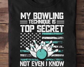 May include: Black t-shirt with a bowling-themed graphic. The design includes the text "MY BOWLING TECHNIQUE IS TOP SECRET NOT EVEN I KNOW WHAT I'M DOING" above a bowling ball and pins, with an American flag design.