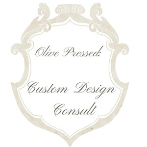 May include: A watercolor-style design featuring a decorative frame with the text "Olive Pressed: Custom Design Consult" in elegant script. The frame is a light beige color, set against a white background.