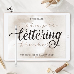 May include: A white tablet displaying the text PROCREATE simple lettering brushes FOR BEGINNERS & ADVANCED in dark brown and beige script and sans-serif fonts, with a white stylus resting vertically on the left side of the screen.