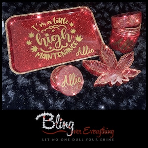 May include: A red glitter resin rolling tray set with gold accents. The tray has the text "I'm a little high maintenance Allie". The set includes a grinder, a storage jar, and a leaf-shaped ashtray.