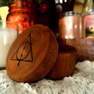 May include: A rustic wooden sign with the text "Welcome to our home" in white lettering. The sign features a distressed finish and a simple, inviting design, perfect for front door decor.