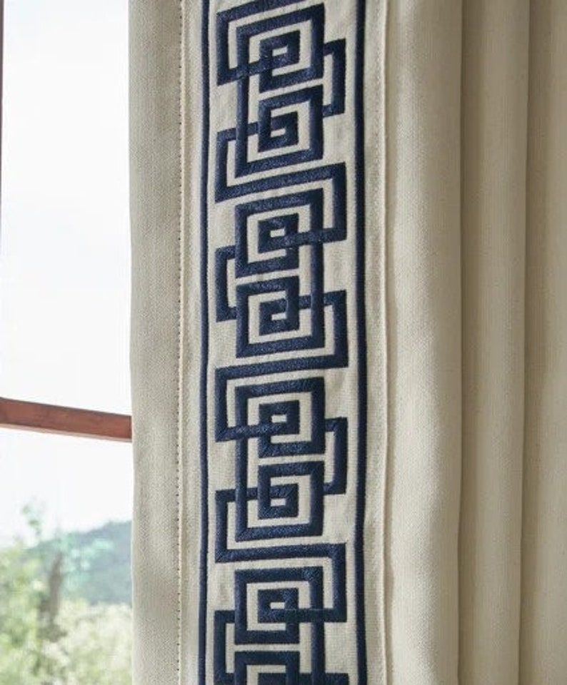 May include: White curtains with a blue geometric pattern embroidered along the edge.