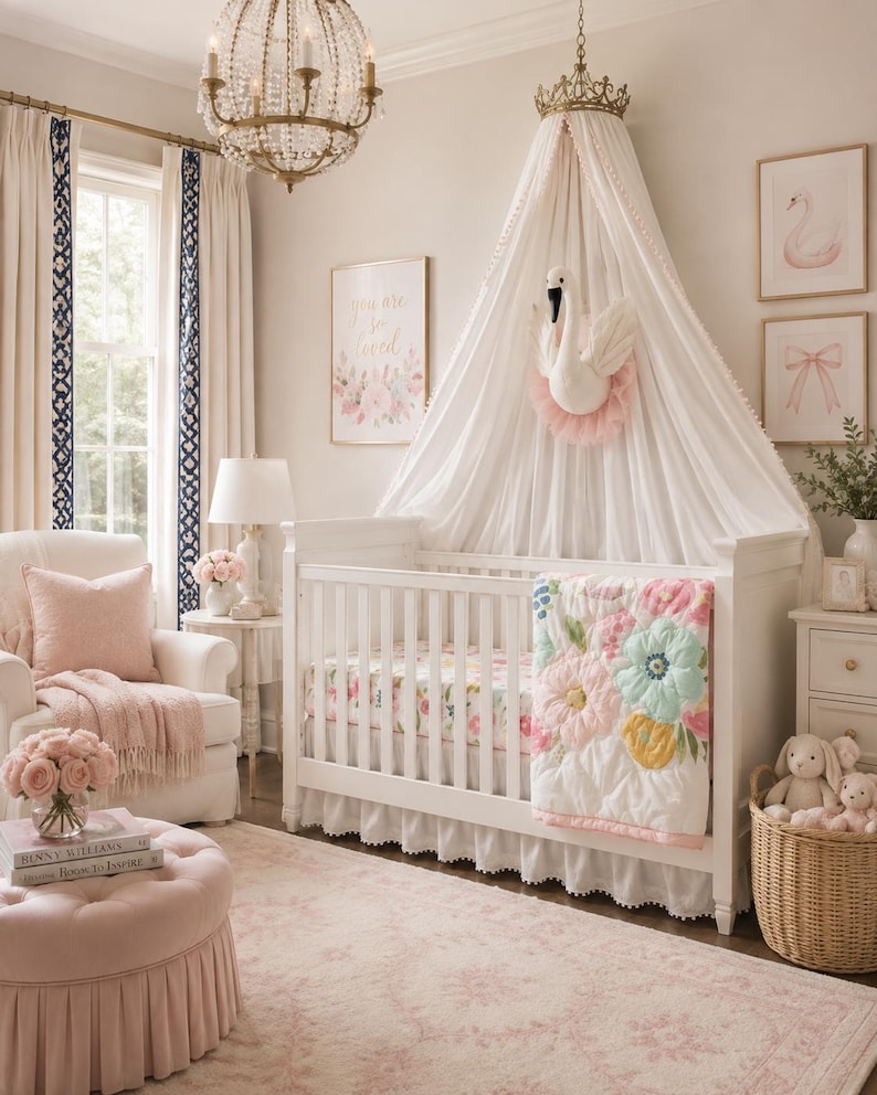 May include: A white wooden crib with a floral quilt, topped by a white fabric canopy featuring a gold crown and a plush swan wall mount. The nursery includes a pink tufted ottoman, a white armchair with a pink pillow, and a wicker basket with plush toys.
