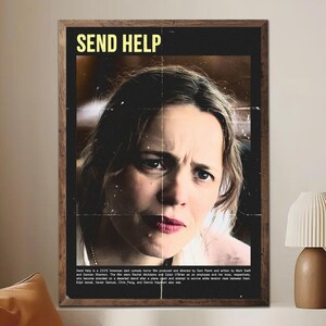 May include: A framed movie poster with the title "SEND HELP" in yellow letters. The poster features a distressed woman's face, split down the middle. The poster has a dark, vintage aesthetic, with text at the bottom.