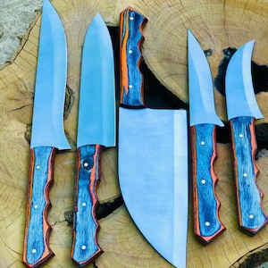 May include: A collection of six kitchen knives with stainless steel blades and blue and orange wood grain handles. The knives are displayed on a wooden surface, including a cleaver, highlighting their different blade shapes and sizes.