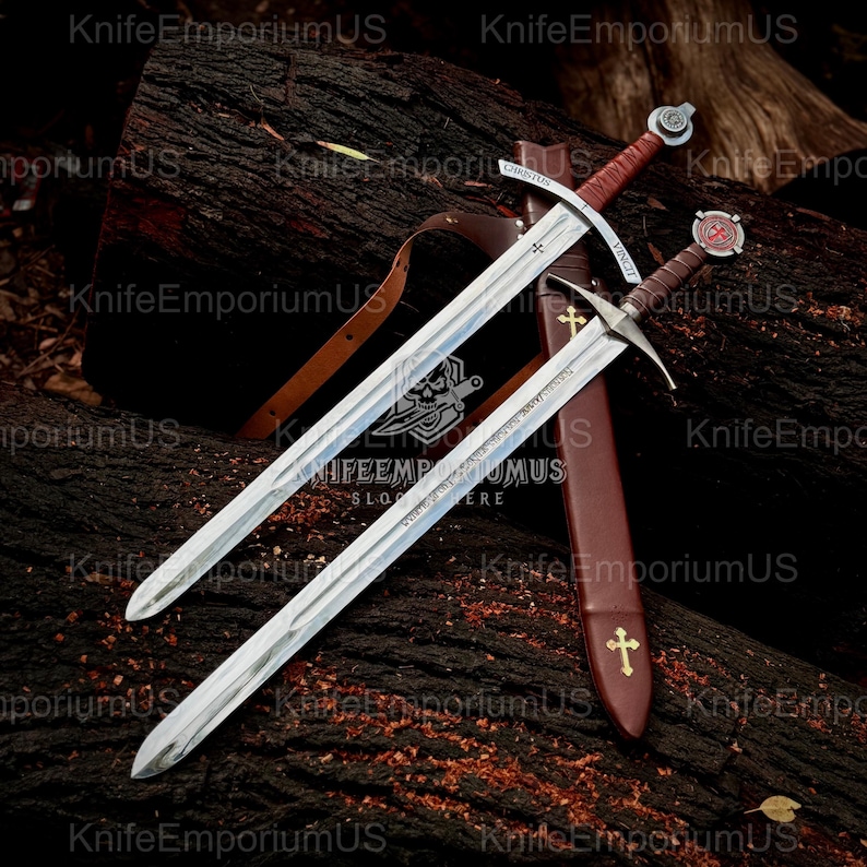 May include: Two medieval swords with silver blades and brown leather-wrapped handles rest on a dark wooden surface. One sword has a cross-shaped hilt and a sheath with a cross emblem. The swords are likely for display or historical reenactment.
