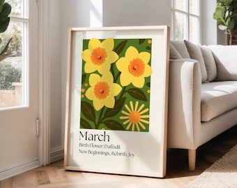 May include: A framed art print featuring a botanical illustration of daffodils. The artwork showcases three large yellow and orange daffodils against a green background. Text at the bottom reads "March, Birth Flower: Daffodil, New Beginnings, Rebirth, Joy."