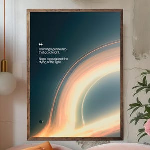 May include: A framed art print featuring a cosmic design with a swirling, bright orange and white light against a dark blue background. The print includes the quote "Do not go gentle into that good night. Rage, rage against the dying of the light."