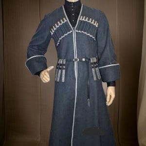 May include: A dark blue, long coat with white trim and decorative accents. The coat features a belt, long sleeves, and a high collar. The garment has a traditional design.
