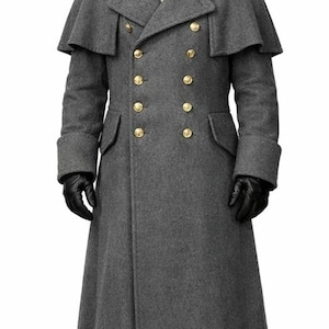 May include: A long grey wool-blend overcoat featuring a double-breasted front with gold-toned buttons, a wide collar, and a shoulder capelet. The coat is paired with black leather gloves, black leather boots, and a black bicorne hat.