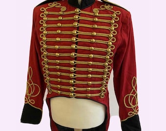 May include: A red military-style jacket featuring a black high collar and black cuffs. The front is decorated with horizontal gold braided cord trim and gold-toned buttons. Each sleeve features gold braided scrollwork embroidery.