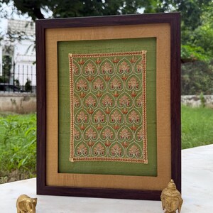 Framed Indian textile artwork styled outdoors with brass decor, ideal as a meaningful Valentine, wedding, anniversary or housewarming gift.