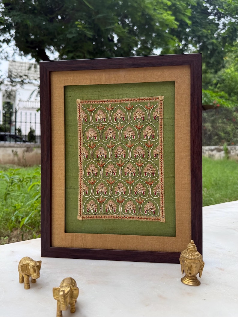 Framed Indian textile artwork styled outdoors with brass decor, ideal as a meaningful Valentine, wedding, anniversary or housewarming gift.