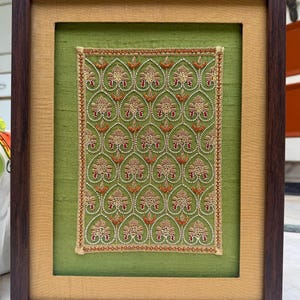 Front view of luxury framed textile art with green silk, gold border and heritage embroidery, perfect for anniversary, engagement or couple gifting.
