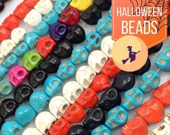 May include: A close-up of a string of colorful skull beads. The beads are made of various materials, including turquoise, white, black, and red. The beads are arranged in a random pattern, creating a visually appealing and festive look. The text "HALLOWEEN BEADS" is visible in the upper right corner of the image.