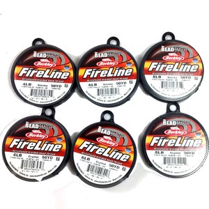 May include: Six spools of Berkley FireLine microfused braided bead thread. The spools are black with red and white text. The spools are labeled with the line's weight, color, and yardage. The spools are arranged in two rows of three.