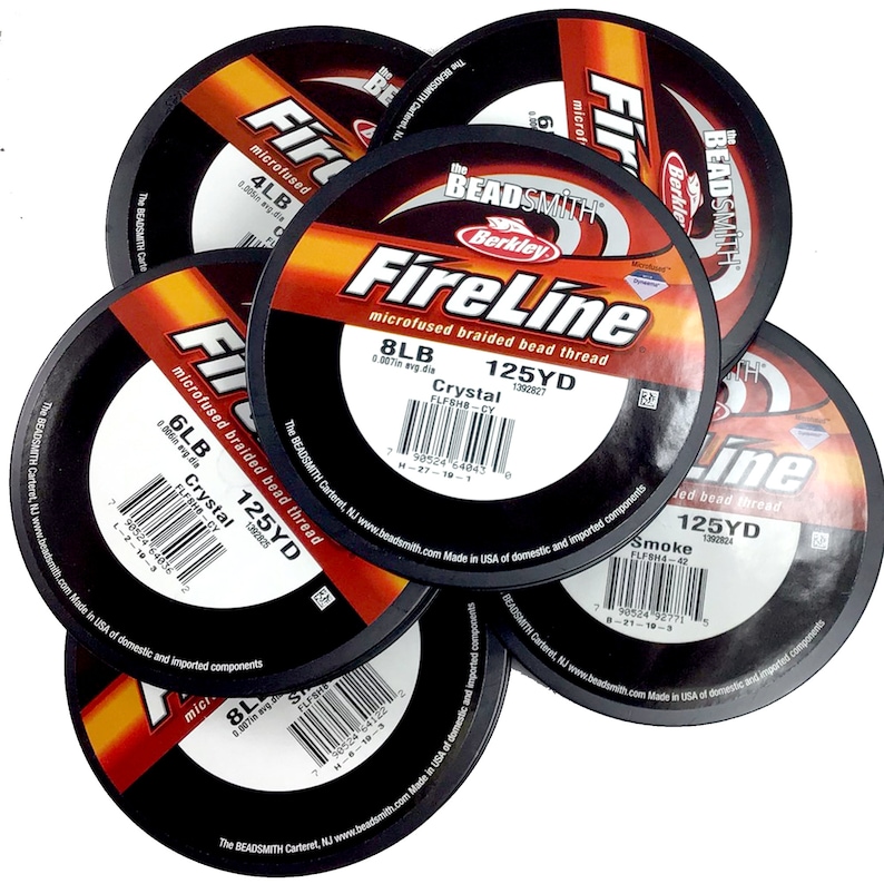 May include: Six spools of black FireLine microfused braided bead thread fishing line. The spools are labeled with the brand name, line type, weight, and yardage. The spools are stacked on top of each other.