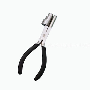 May include: A silver-toned jewelry making tool with black rubber handles. The tool has a series of round metal rings on the top for creating loops in wire.