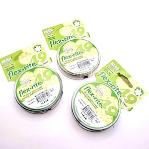 May include: Several spools of clear, nylon-coated stainless steel micro-wire, labeled "flex-rite 49". The packaging includes green and white cards with product information. The wire spools are in silver containers.