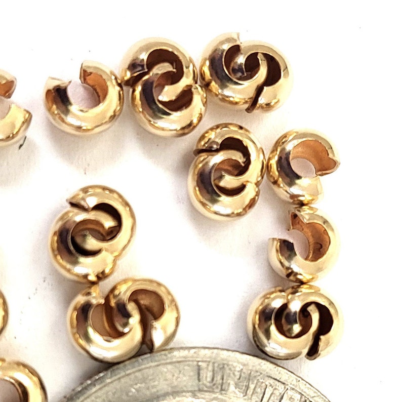 May include: Gold-toned metal bead caps for jewelry making. The caps are designed to be used with cord or string to create a secure closure.
