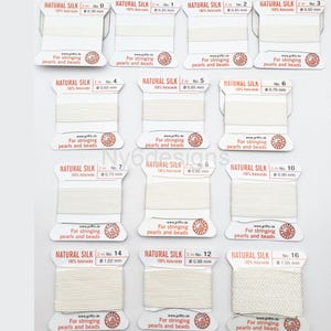 May include: A set of 10 spools of natural silk thread for stringing pearls and beads. The spools are labeled with the thread size in millimeters and the number of meters of thread on each spool.