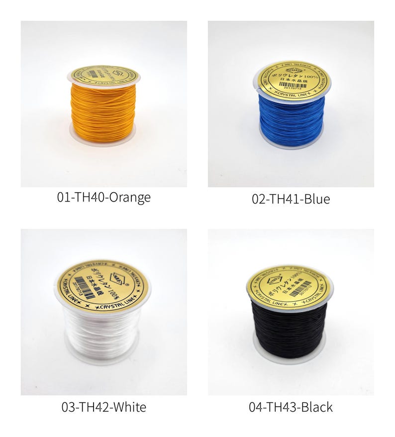 May include: Four spools of elastic beading cord in orange, blue, white, and black. Each spool has a gold label with Japanese text. The spools are labeled 01-TH40-Orange, 02-TH41-Blue, 03-TH42-White, and 04-TH43-Black.