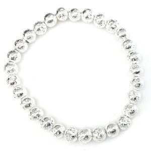 May include: A silver beaded bracelet with textured, spherical beads. The bracelet is made of small, round beads strung together, creating a flexible and stylish accessory. The beads have a hammered or textured appearance.