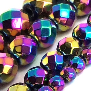 May include: A strand of iridescent faceted gemstone beads. The beads are a deep black with a rainbow sheen, with colors of purple, blue, green, and gold.