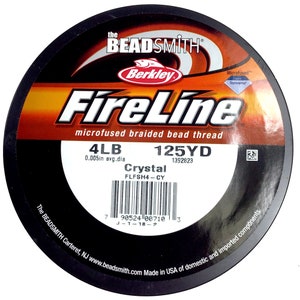 May include: A spool of 4lb FireLine Crystal microfused braided bead thread fishing line in a black and orange container. The spool is labeled with the brand name "Berkley" and the text "125YD 1392823".