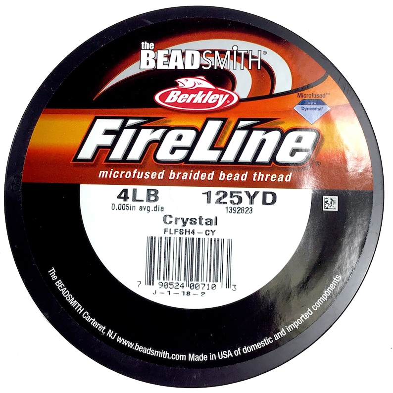 May include: A spool of 4lb FireLine Crystal microfused braided bead thread fishing line in a black and orange container. The spool is labeled with the brand name "Berkley" and the text "125YD 1392823".