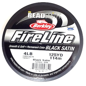 May include: A spool of black Berkley FireLine fishing line with the text "Black Satin" and "Microfused" with Dyneema. The spool is labeled 4lb, 0.005in avg. dia, 1424477, 125yd, 114m, and FLFSH4-BSN.