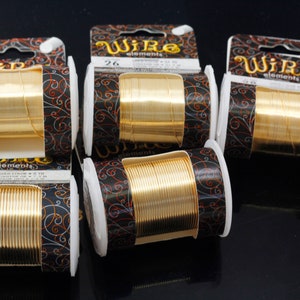 May include: Five spools of gold wire, each wrapped in black and gold packaging with the text "Wire elements" printed on the label. The spools are labeled with the gauge of the wire, 16 and 26.