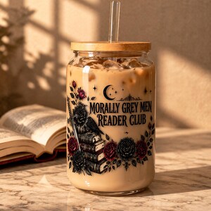 Glass tumbler with lid and straw, reading "Morally Grey Men Reader Club."