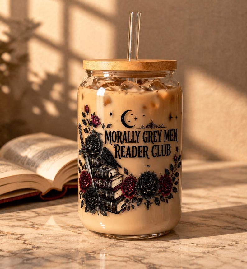 Glass tumbler with lid and straw, reading "Morally Grey Men Reader Club."