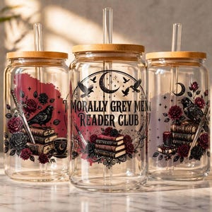 Three glass tumblers with wooden lids featuring dark floral and bird motifs.