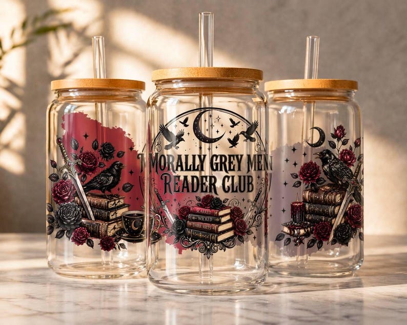 Three glass tumblers with wooden lids featuring dark floral and bird motifs.